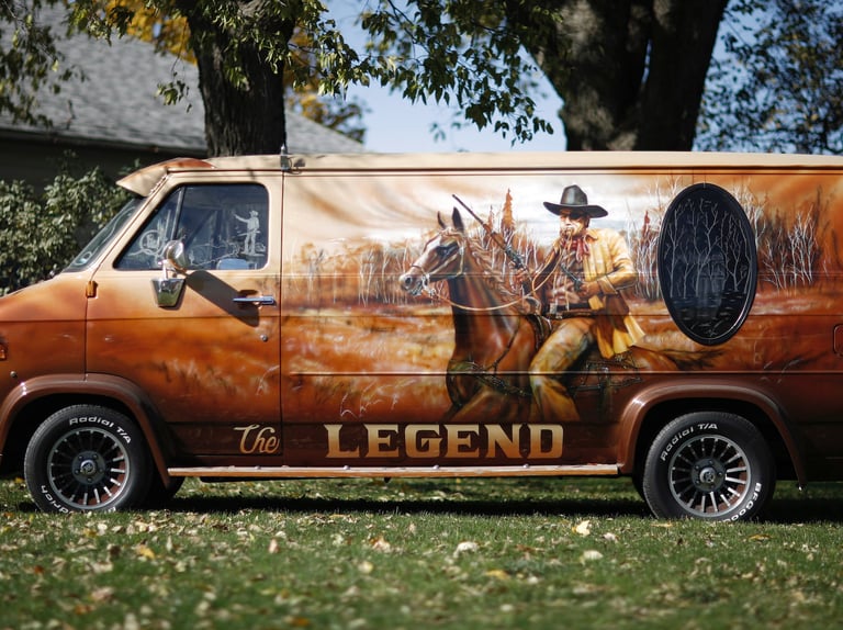 a van with a man on it's side of the van