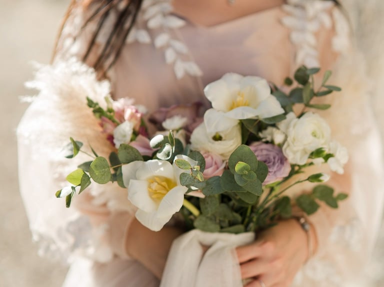 Elegant bride holding bouquet during prewedding session at Melasti Beach Bali