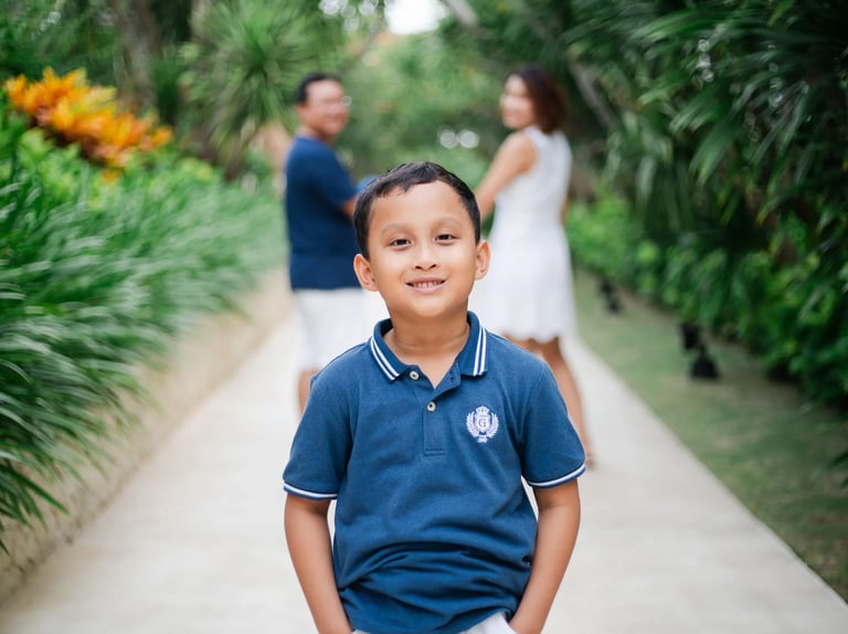 Boy portrait on tropical walkway during family session at The Mulia Nusa Dua Bali