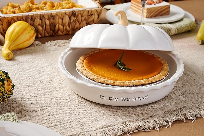 A white pumpkin shaped pie dish on top of a dining table.