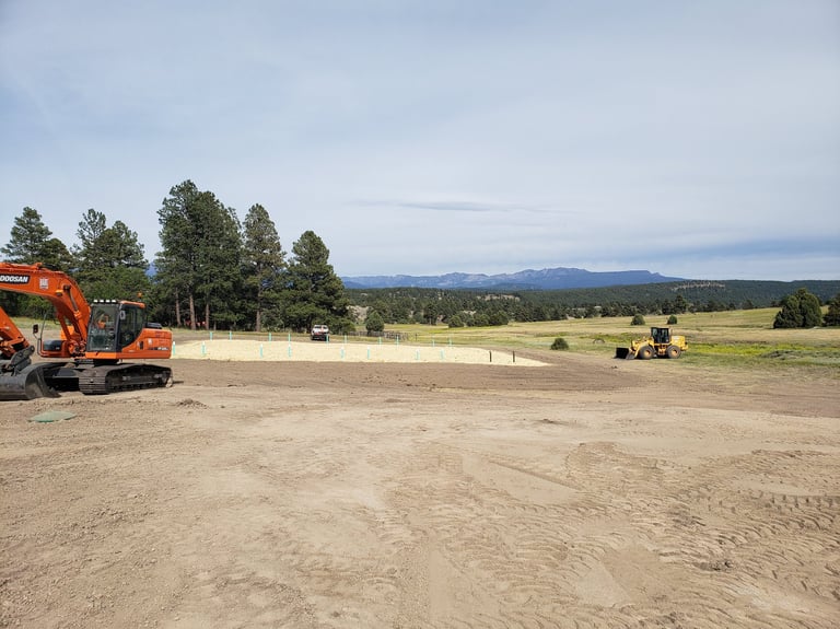 a tractor with a tractor loader in the background