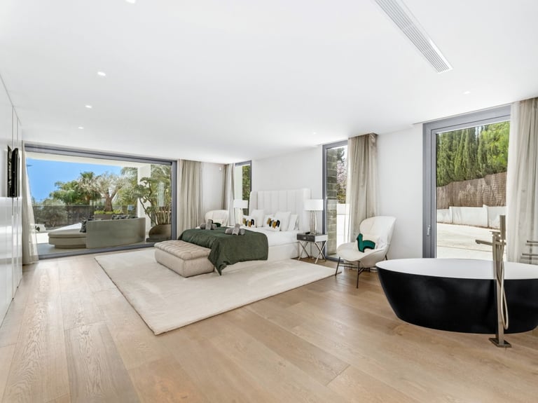 Contemporary designer suite at Villa Serenity, featuring clean lines and a soft, neutral palette