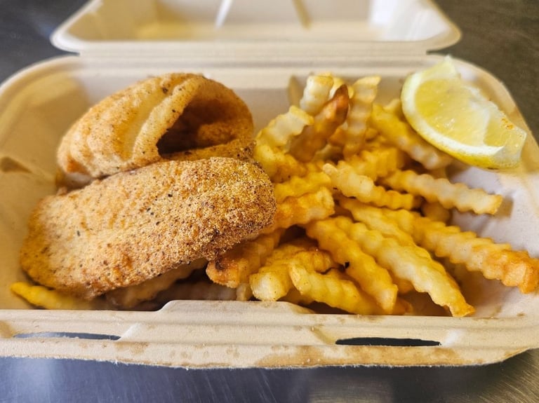 Lighter portion fried catfish meal with crispy crinkle cut fries at Captain's Galley
