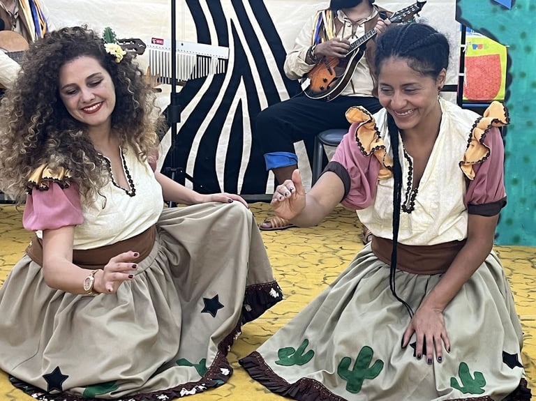 two women in costumes and costumes are sitting on the floor