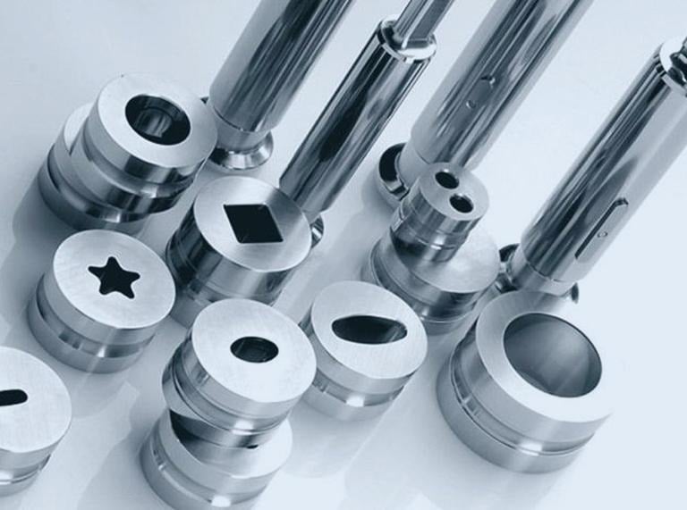 Precision pharmaceutical tablet press tooling and polished stainless steel punch die sets.