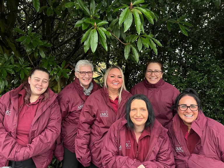 Image of the AMG Nursing & Care services team outside in their branded jackets