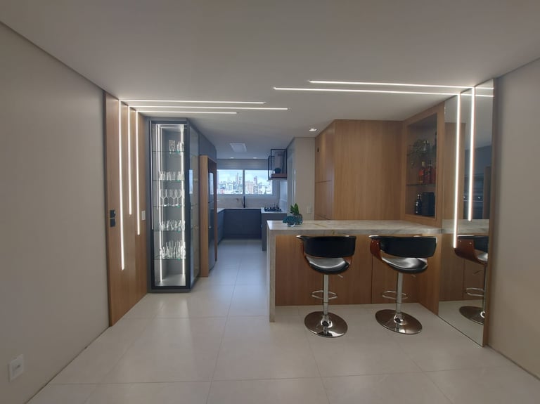 a kitchen with a bar stool and bar stools