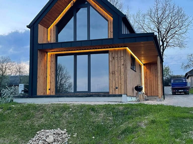 a house with a large window and a car parked in front of it