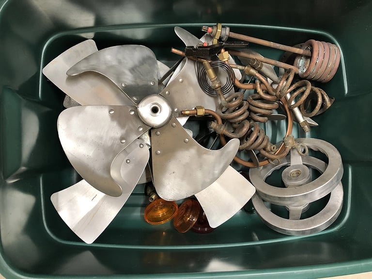 Metal parts in a sculptor's workshop bin, image 2.