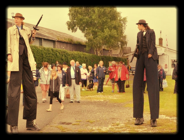Two performers in in gangster suits on stilts speakeasy themed entertainment 