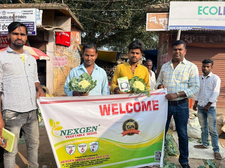 a group of men standing in front of a banner board of NEXGEN SEEDS CAULIFLOWER 