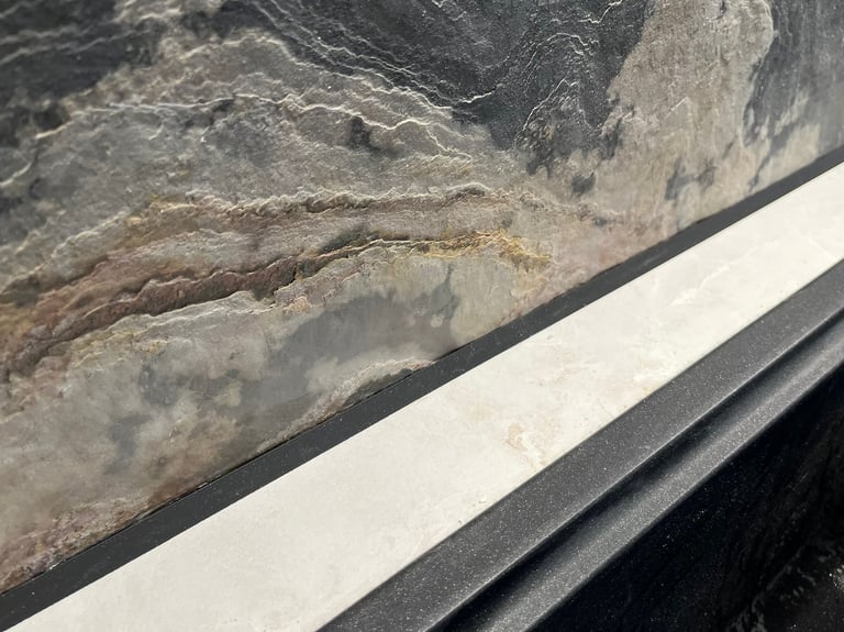 Natural dark slate stone tile texture with layered rock patterns for modern interior design.