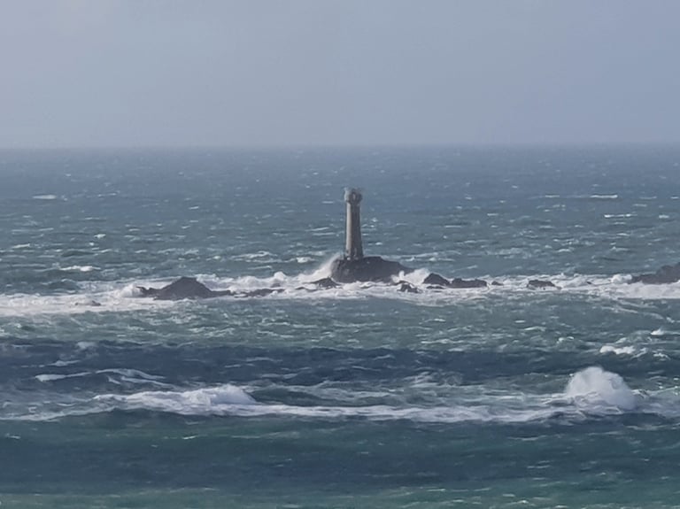 Longships lighthouse off Lands End in Cornwall in choppy, stormy seas