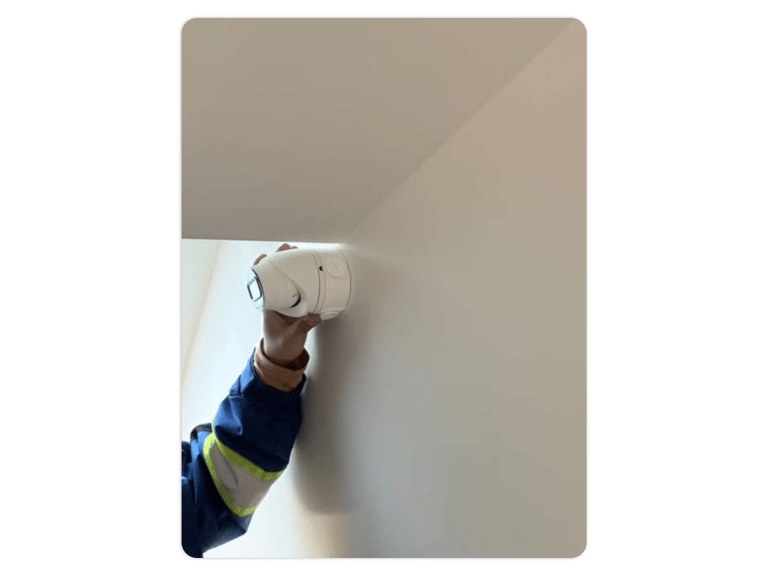 a man is holding a security camera