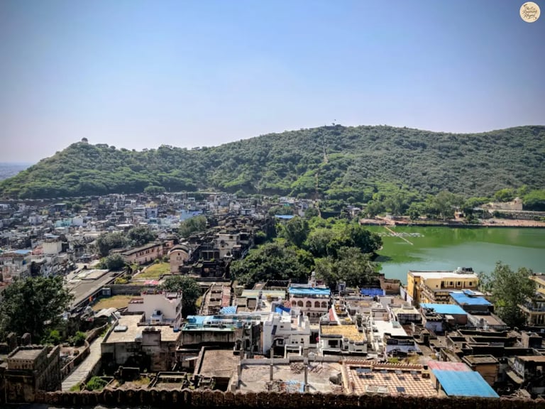 Panoramic view of Bundi town and Nawal Sagar Lake from Garh Palace, capturing the blue houses, serene waters, and royal charm