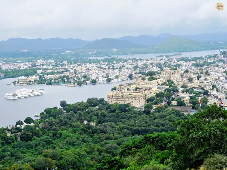 Panoramic hilltop view of Lake Pichola, City Palace, and Fateh Sagar Lake as seen from Karni Mata Temple in Udaipur.
