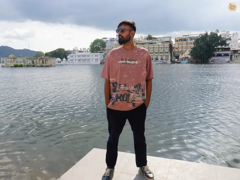 Serene lakeside scene with cloudy skies at Gangaur Ghat Udaipur Rajasthan India.