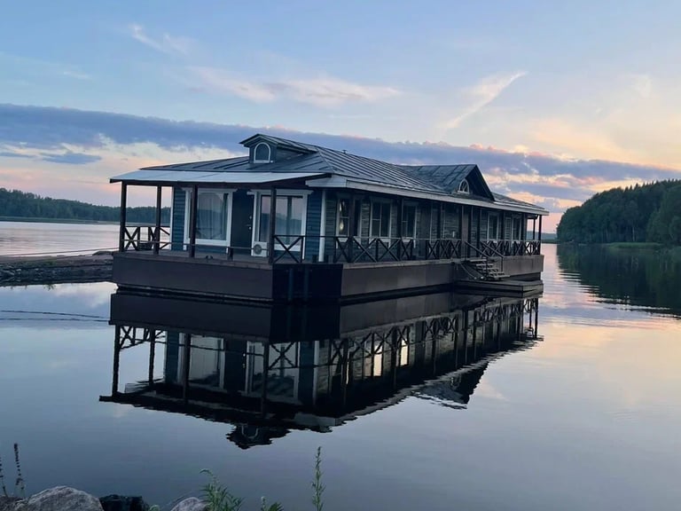 a houseboater is sitting on a dock with a view of the water