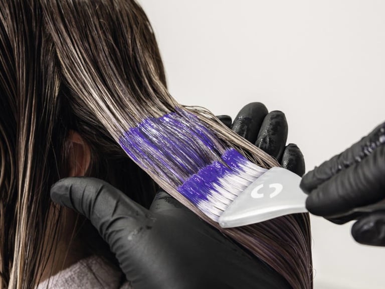 a woman is shown in a salon while her hair is dyed out
