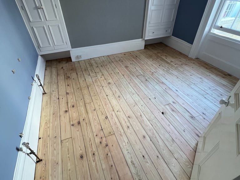 Stripped pine floorboards in Worthing Sussex, wooden floor restoration before finish