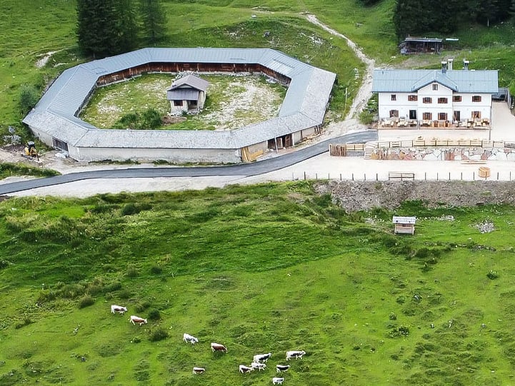farm house malga misurina with a circular shaped building