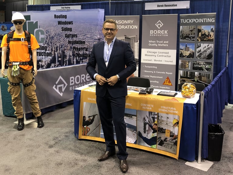 Borek Renovation's owner at a professional trade show booth for masonry restoration.
