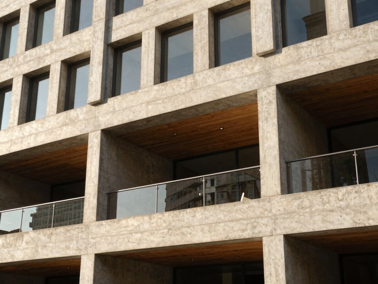 Tight abstract detail of a modern commercial office building made of raw concrete and warm timber, sharp natural light play, deep shadows