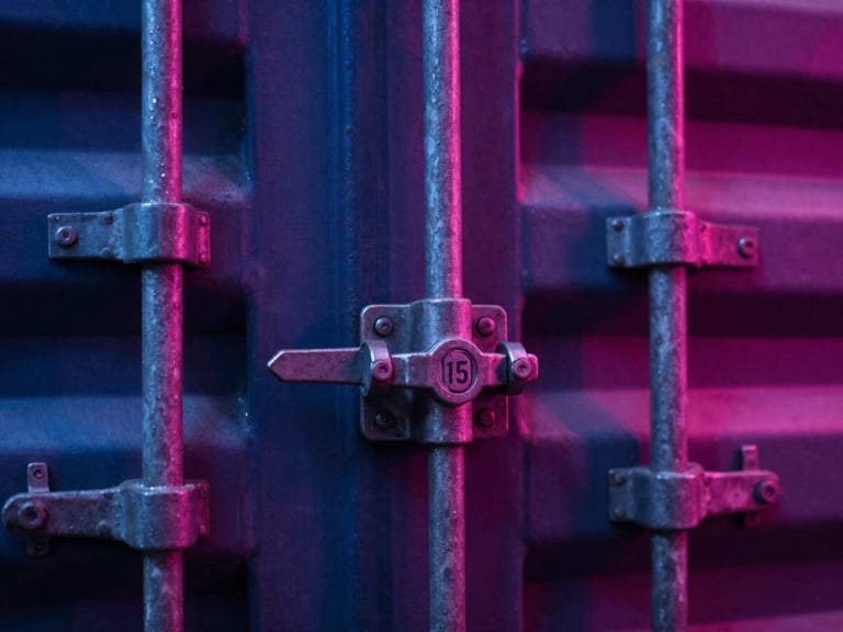 Macro shot of a heavy-duty steel cargo container lock with a secure numbered seal, dramatic high-contrast industrial lighting, 35mm.