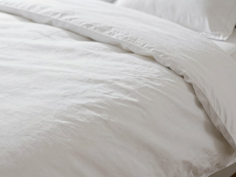 Extreme close-up of 500 TC white luxury bed linen, macro shot showing perfect thread density, soft morning daylight, 35mm