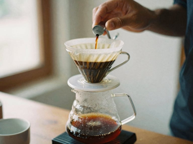 Close-up of a V60 pour-over coffee dripping into a glass carafe, barista's hands carefully pouring water, soft side-lit window daylight, rich espresso and cream tones, shallow depth of field, 35mm film