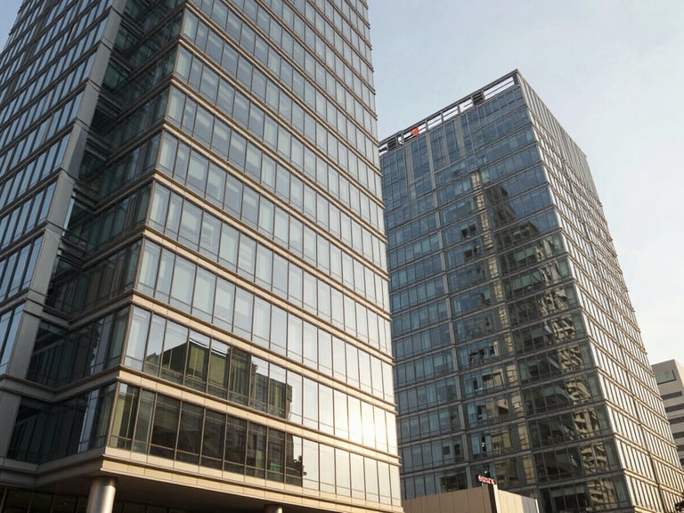 Wide-angle architectural shot of modern glass office towers in Kharadi under bright afternoon sunlight, high-contrast architectural detail, warm editorial photography, 35mm lens