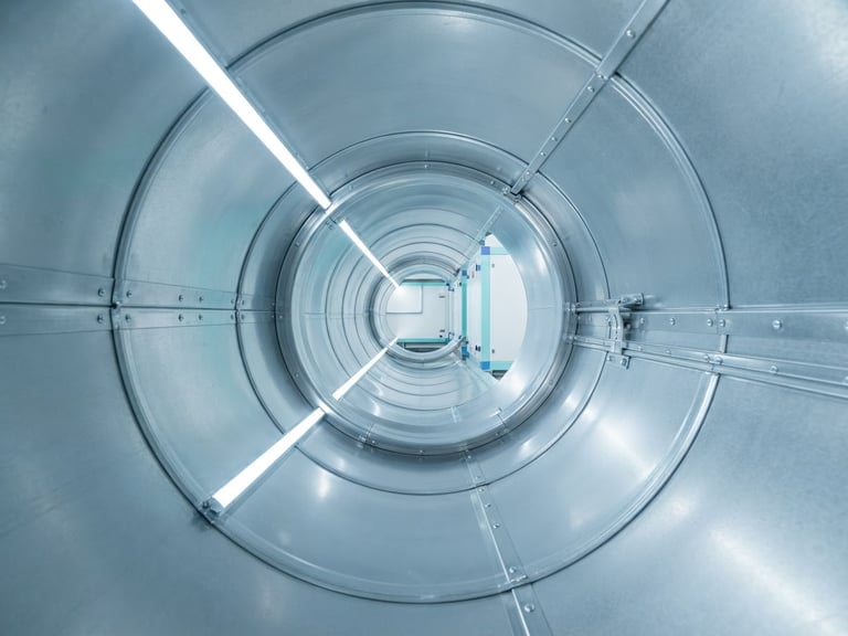 Pristine metal duct interior reflecting bright clean LED light, clinical sharp focus, 35mm