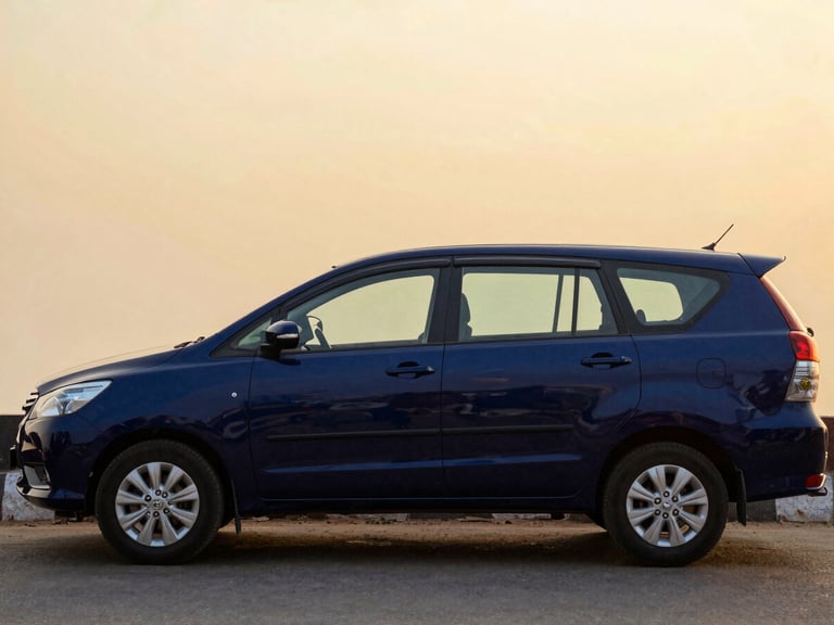 Side profile of a polished dark blue Toyota Innova Crysta parked on a quiet street in Vrindavan, dusk lighting