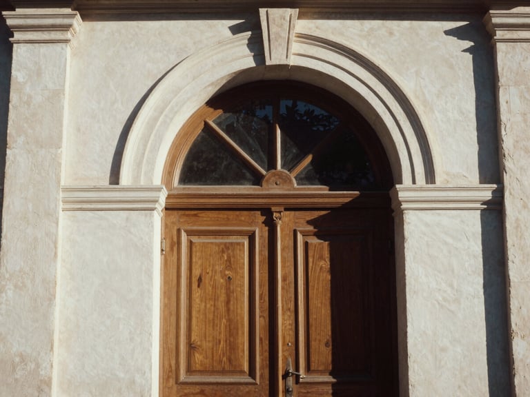 Warm late-afternoon sun hitting a classic arched doorway in Athens, elegant architectural detail, medium format film.