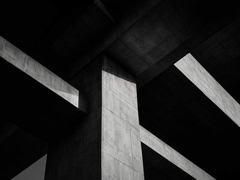 Extreme close-up of a massive concrete bridge pier junction, sharp shadow play, dramatic late-afternoon light, technical structural precision.