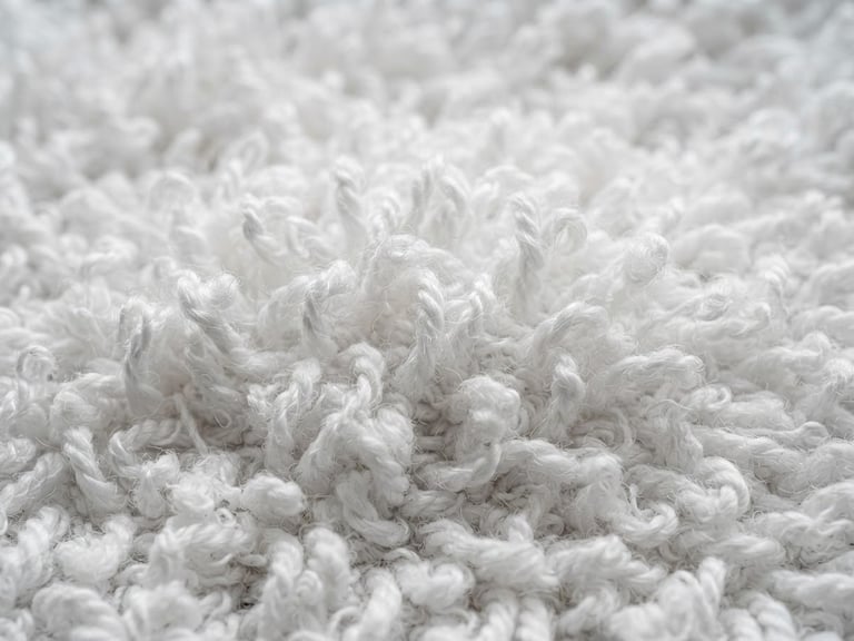 Close-up macro photography of clean white terry towel loops under bright neutral daylight, crisp textile textures, desaturated teal tones, 50mm lens