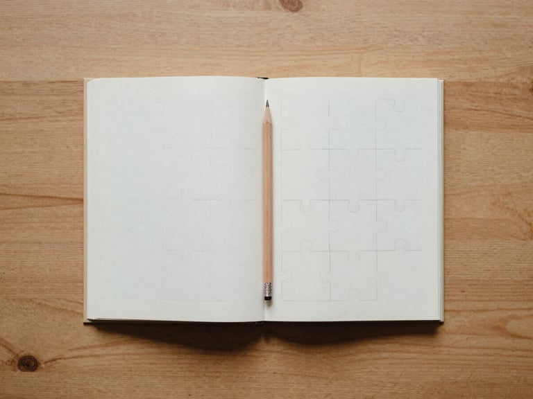 Overhead flat-lay of an open puzzle book on a clean wooden table, a sharp pencil resting on the page, soft morning light