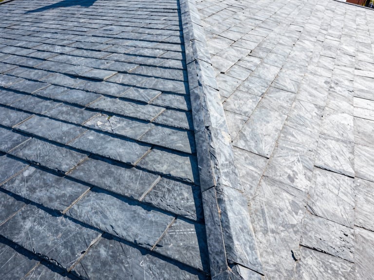High-angle architectural shot of a clean finished slate roof in bright natural daylight, sharp geometric lines, wide-angle lens