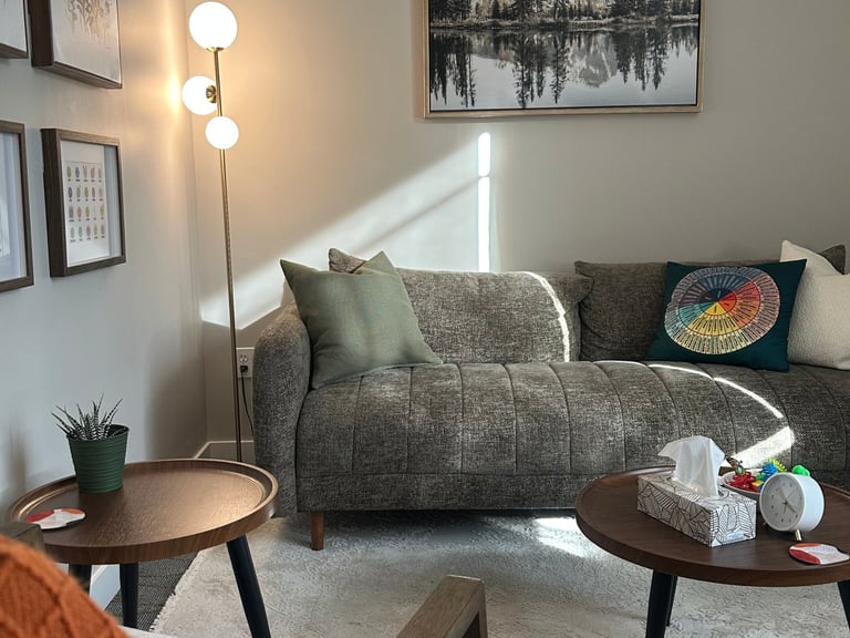 Warm, inviting therapy room with a prompt to book a free 20-min consult at Tri Lotus Psychotherapy