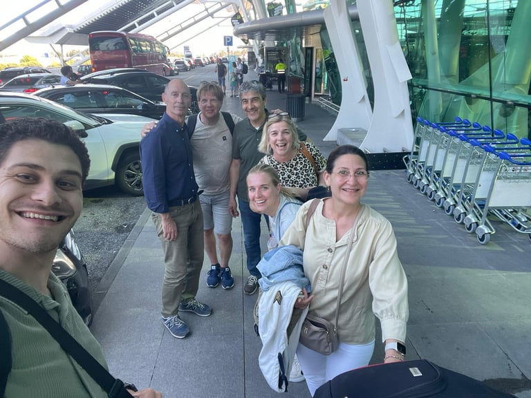 a group of people standing around a luggage carton