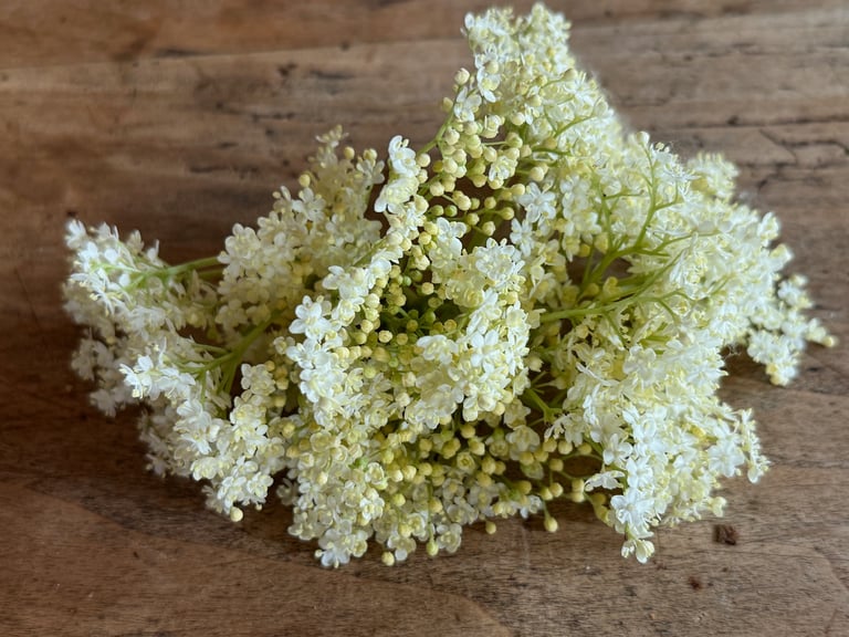 a bunch of white flowers on a wooden table