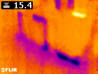 Infrared camera detecting hidden water damage in wall