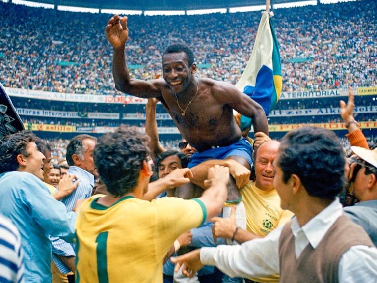 a man pelé world cup 1970 chapion is holding a man's hand while he is holding a flag