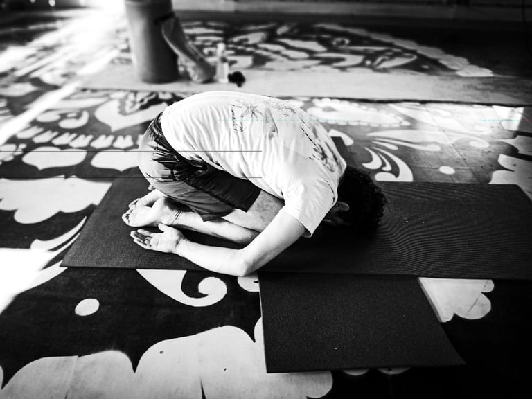 A yoga practitioner executes the Child Pose