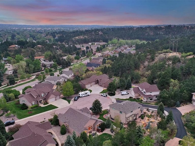 a neighborhood with houses and trees in the foreground