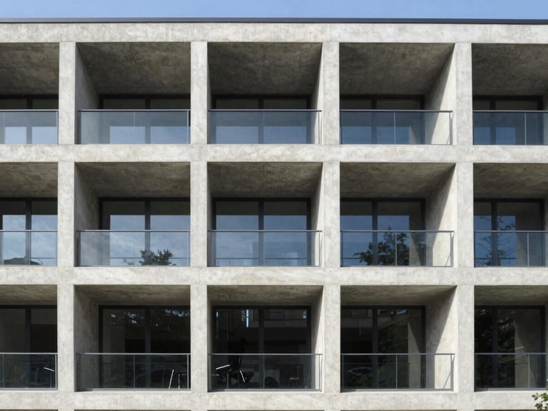 Straight-on architectural elevation of a modern concrete building under bright daylight, crisp shadows, clean structural lines, 35mm
