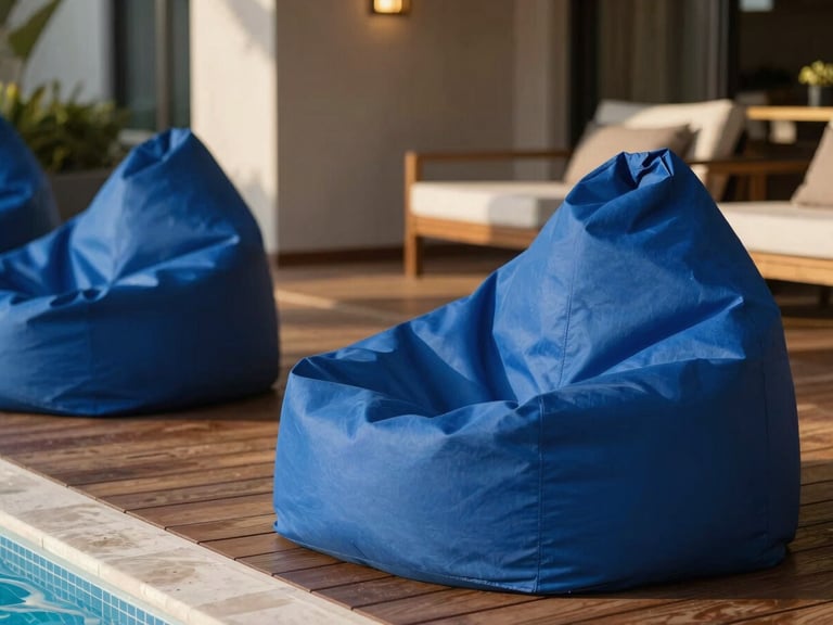 A sunlit modern resort lounge overlooking a pool, premium royal blue structured bean bags placed elegantly on a wooden deck, warm side-light, 35mm