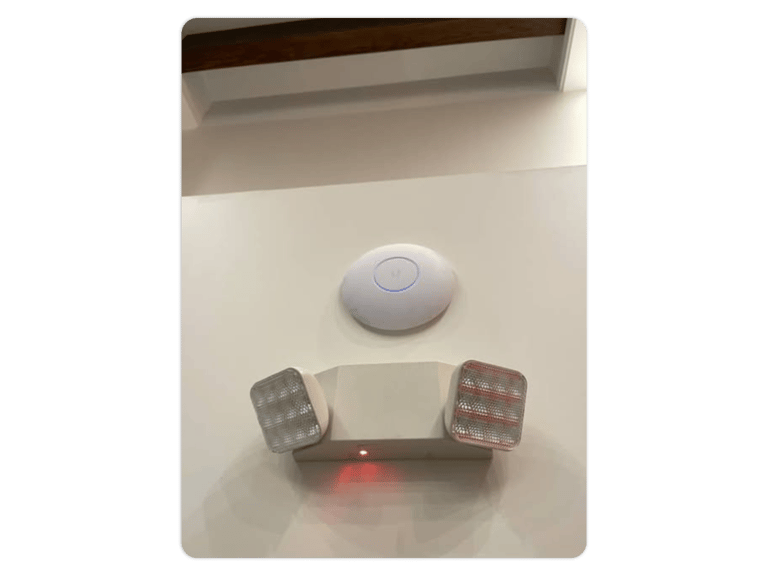 a wall mounted light fixture with a remote control