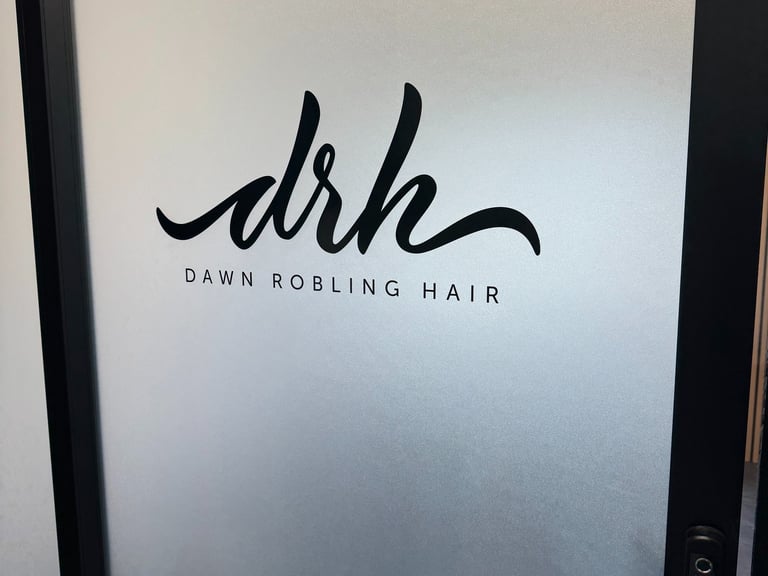Frosted glass door with custom black Dawn Robling Hair logo decal installed by Big Sticker