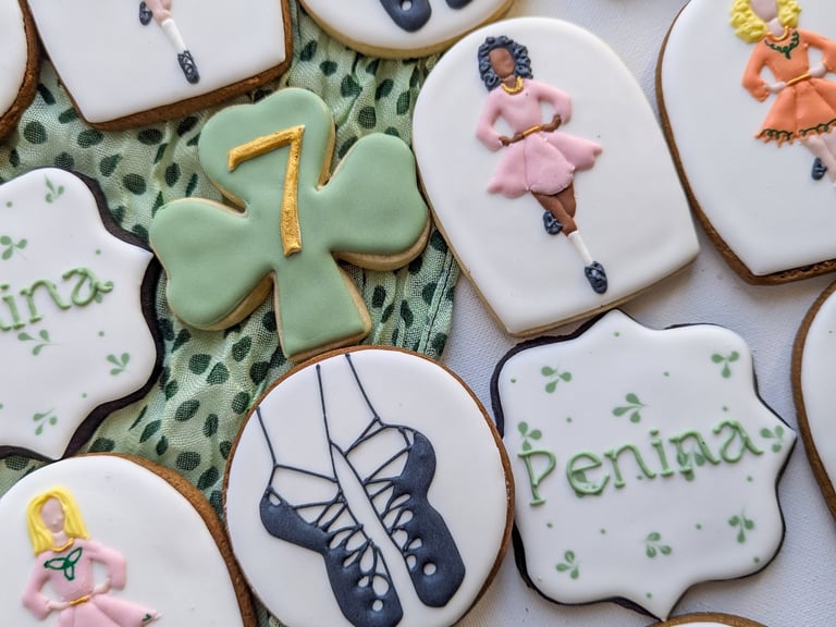 Cookies with Irish step dance theme with dancers, shoes, shamrocks in various colors